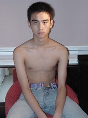 Young Japanese guy poses in front of the camera